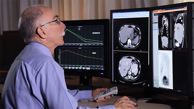 a man looking at clinical images on a monitor